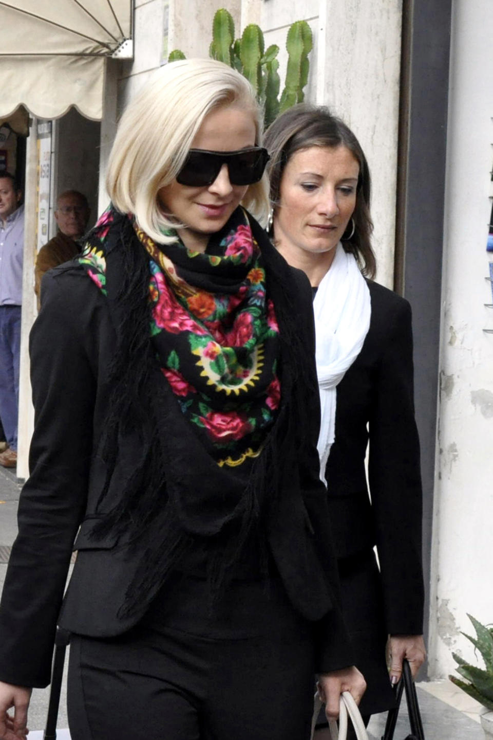 Domnica Cemortan, from Moldavia, left, arrives at the converted Teatro Moderno theater to testify in a hearing in the trial of Captain Francesco Schettino, in Grosseto, Italy, Monday, Oct. 28, 2013. The captain of the wrecked Costa Concordia is charged with manslaughter, causing the shipwreck and abandoning ship before the luxury cruise liner's 4,200 passengers and crew could be evacuated on Jan. 13, 2012 when the ship collided with a reef off the Tuscan island of Giglio, killing 32 people. (AP Photo/Giacomo Aprili)
