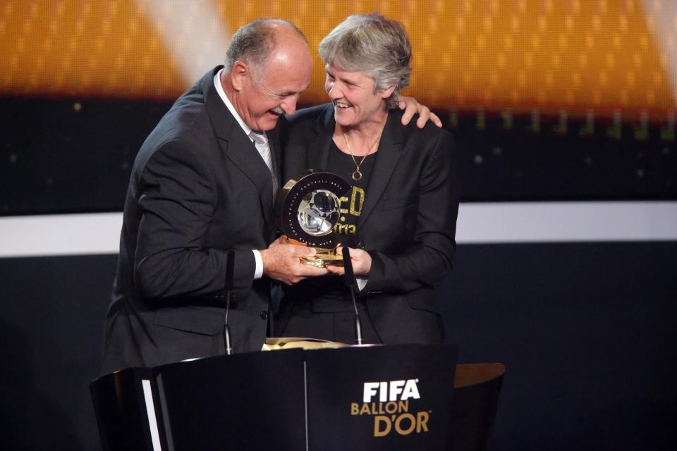 ZURICH, SWITZERLAND - JANUARY 07: Pia Sudhage, women's coach of United States receives the FIFA World Coach of Women's Football 2012 trophy by Felipe Scolari (L) at Congress House on January 7, 2013 in Zurich, Switzerland. (Photo by Christof Koepsel/Getty Images)