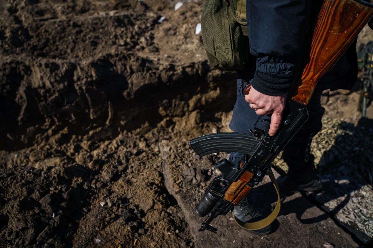 A volunteer fighter walks in the trenches ready to defend Kyiv.