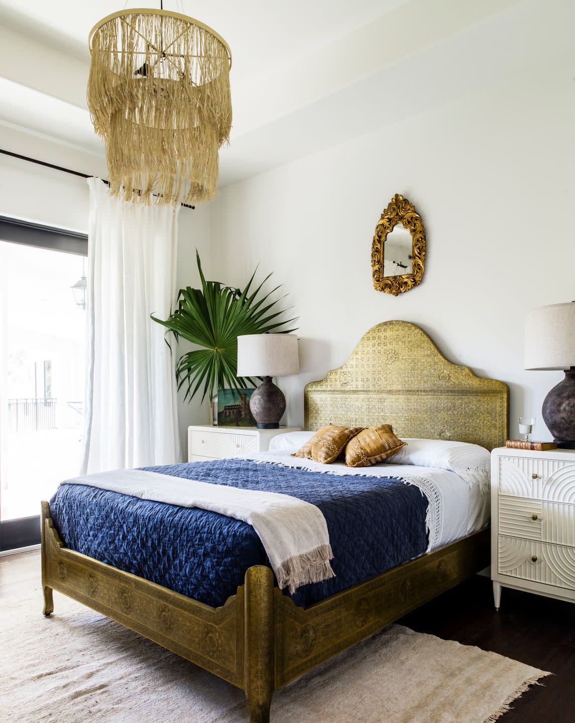 guest bedroom the placement of a small antique mirror emphasizes the gold anthropologie bed nightstands anthropologie curtains and rod rh lamps arteriors