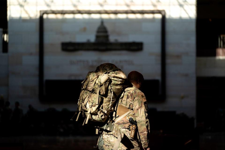 <p>A member of the National Guard walks through the Visitor Center of the U.S. Capitol on January 13, 2021 in Washington, DC.</p>