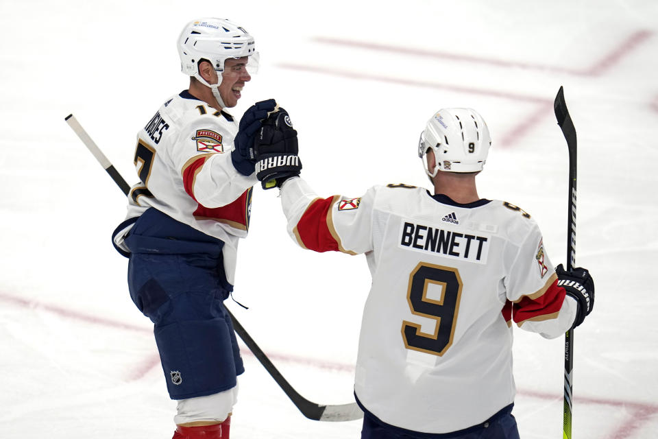Florida Panthers' Evan Rodrigues, left, celebrates his goal against the Pittsburgh Penguins with Sam Bennett (9) during the first period of an NHL hockey game in Pittsburgh, Friday, Jan. 26, 2024. (AP Photo/Gene J. Puskar)