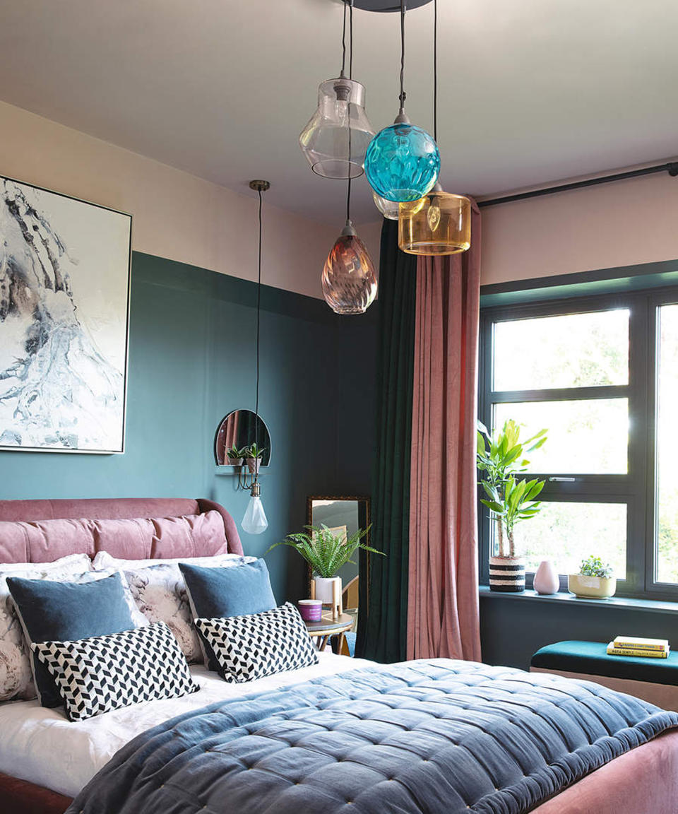 a small bedroom with statement pendant light and pendant lights at the bedsides - Katie Lee