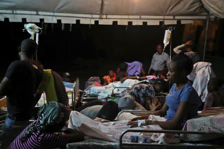 People injured in an earthquake that hit northern Haiti late on Saturday, are being looked after in a tent, in Port-de-Paix, Haiti, October 7, 2018. REUTERS/Ricardo Rojas