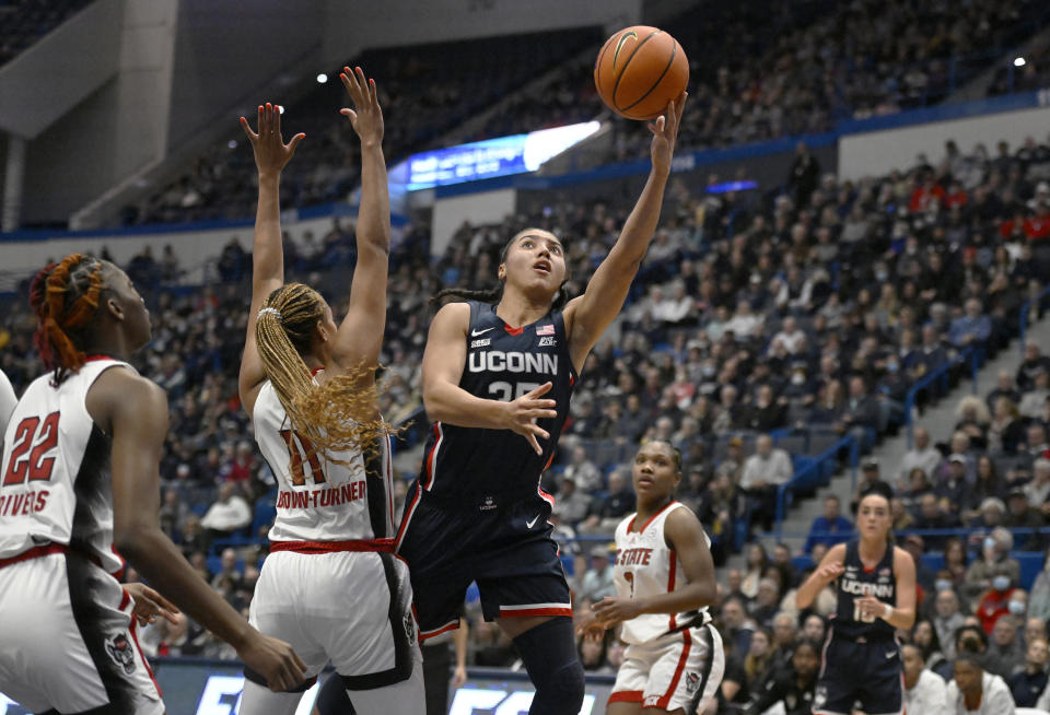 Connecticut's Azzi Fudd (35) goes up for a basket against NC State's Jakia Brown-Turner (11) during the first half of an NCAA basketball game, Sunday, Nov. 20, 2022, in Hartford, Conn. (AP Photo/Jessica Hill)