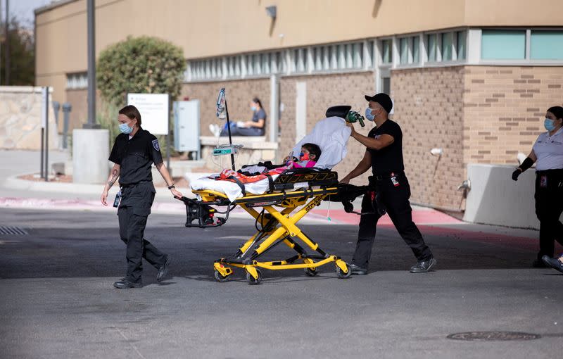 A boy is wheelded on a stretcher is moved outside the ermergency room at University Medical Center in El Paso