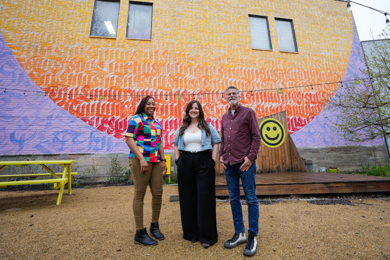 Members of the Walnut Hills Redevelopment Foundation, Ashley Gibbs, Samantha Reeves and Gary Dangel pose in Five Points Alley.