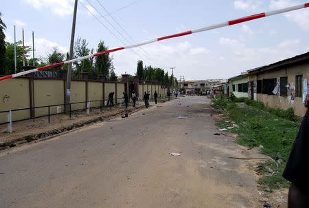 Security personnel seal the scene of a bomb attack in Kano July 27, 2014. REUTERS/Stringer