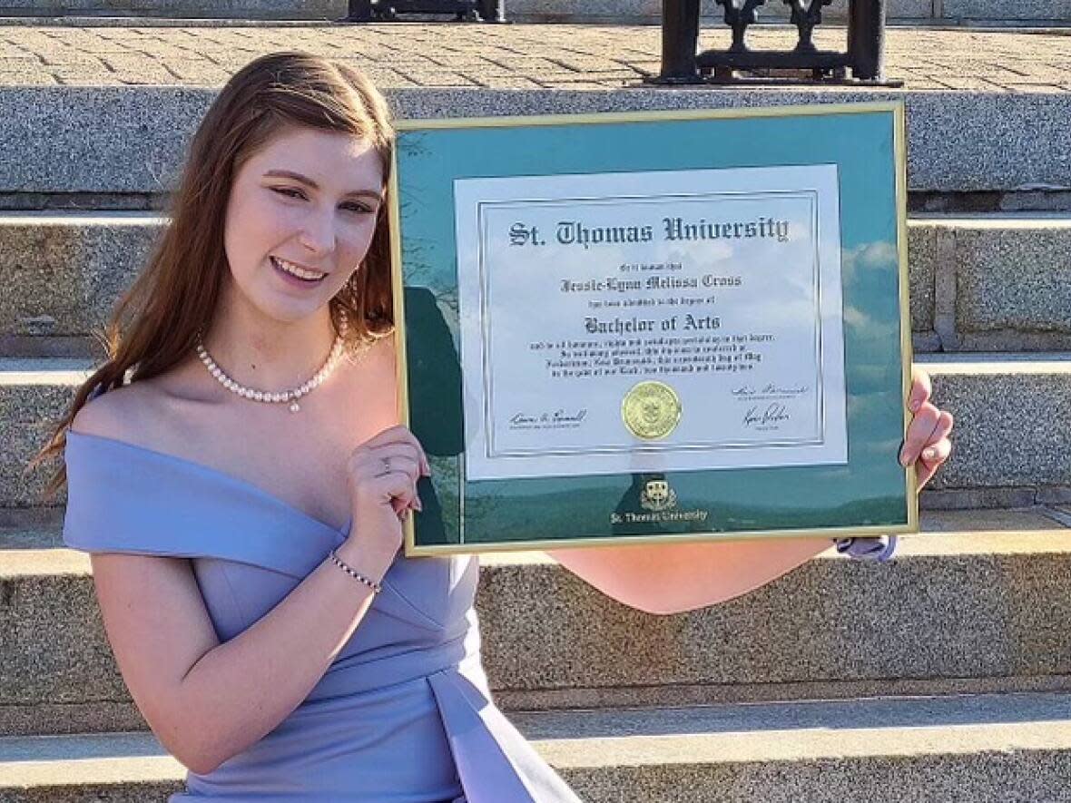 Jessie-Lynn Cross proudly displays the certificate she received on the day of her convocation with a bachelor of arts degree in criminology and criminal justice, and human rights, from St. Thomas University. (Submitted by Jessie-Lynn Cross - image credit)