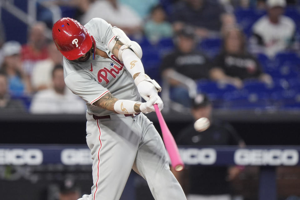 Philadelphia Phillies' Nick Castellanos hits a home run scoring Alec Bohm and Bryce Harper during the first inning of a baseball game against the Miami Marlins, Sunday, May 12, 2024, in Miami. (AP Photo/Wilfredo Lee)