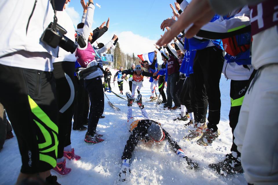 Robin Duvillard (front) and Jean Marc Gaillard of France dive in the snow to celebrate winning the bronze medal after the Cross Country Men's 4 x 10 km Relay during day nine of the Sochi 2014 Winter Olympics at Laura Cross-country Ski & Biathlon Center on February 16, 2014 in Sochi, Russia.