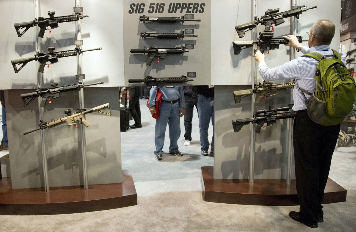 Image: A convention attendee looks at semiautomatic rifles at the National Shooting Sports Foundation's annual trade show in Las Vegas in 2013. (Julie Jacobson / AP file)