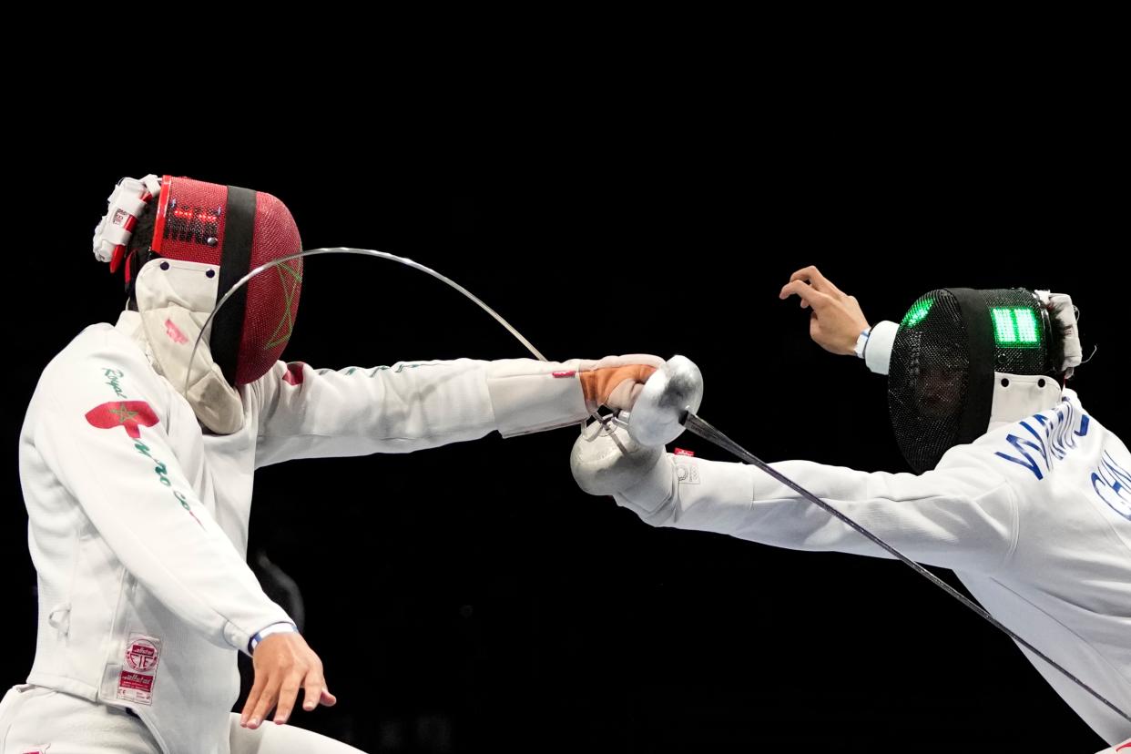 Zijie Wang of China, right, and Houssan Elkord of Morocco compete in the men's individual round of 32 Epee competition at the 2020 Summer Olympics, Sunday, July 25, 2021, in Chiba, Japan.