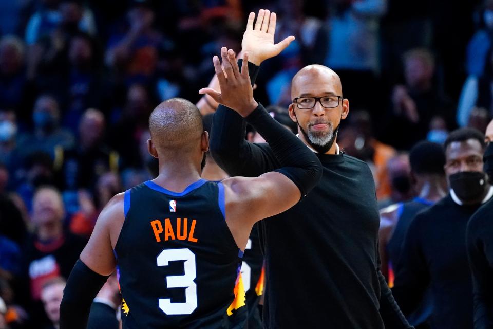 Phoenix Suns guard Chris Paul (3) high fives head coach Monty Williams during the second half of an NBA basketball game against the Golden State Warriors, Tuesday, Nov. 30, 2021, in Phoenix. The Suns won 104-96. (AP Photo/Matt York)