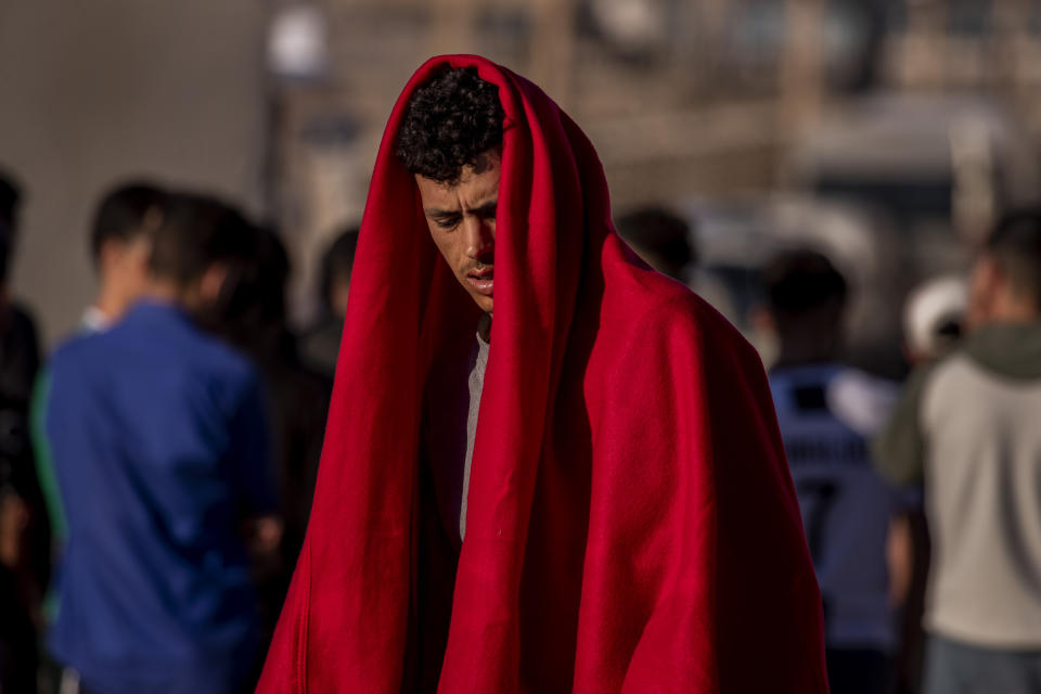 A migrant waits at the Spanish enclave of Ceuta, near the border of Morocco and Spain, Wednesday, May 19, 2021. Spanish officials are acknowledging for the first time that the unprecedented migrant crisis has been triggered by an angry Rabat at Madrid's decision to provide medical treatment to the militant boss of the Polisario Front. (AP Photo/Bernat Armangue)