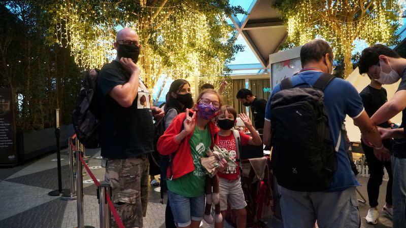 A family poses after checking in for an indoor 'glamp-cation' at Changi Airport, Singapore