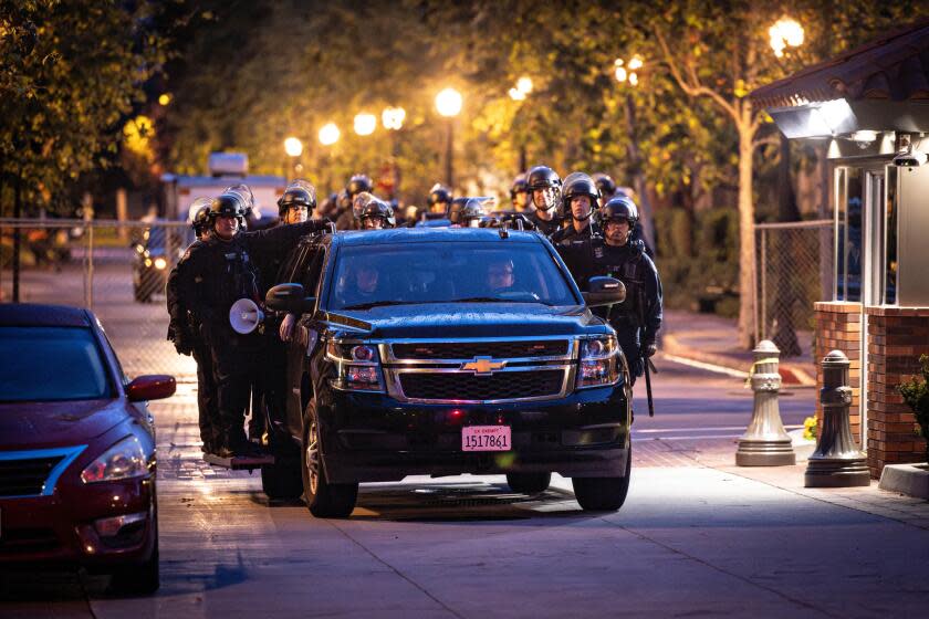 Los Angeles, CA - May 05: LAPD officers in riot gear exit USC after they cleared out a pro-Palestinian protest encampment on Sunday, May 5, 2024 in Los Angeles, CA. (Jason Armond / Los Angeles Times)