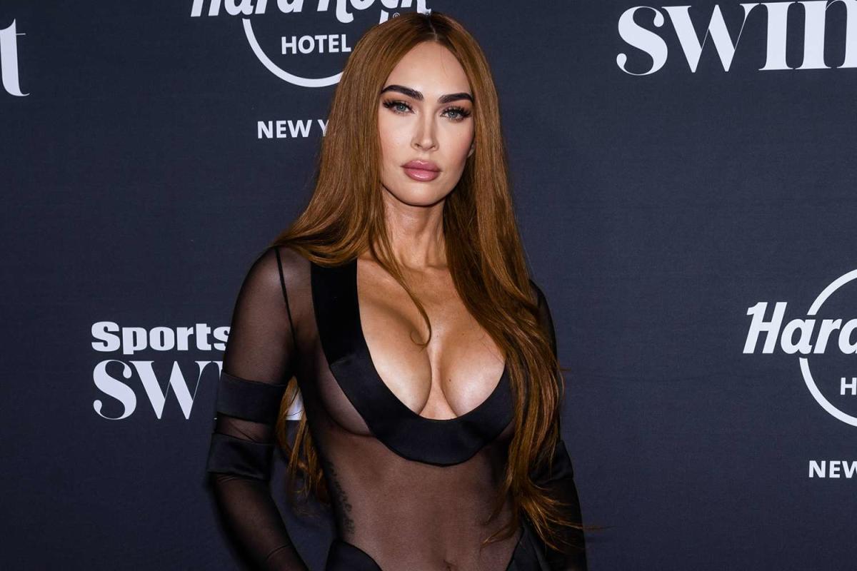 Megan Fox rocks a plunging sheer dress and fiery red hair at the Sports Illustrated Swimsuit party in NYC