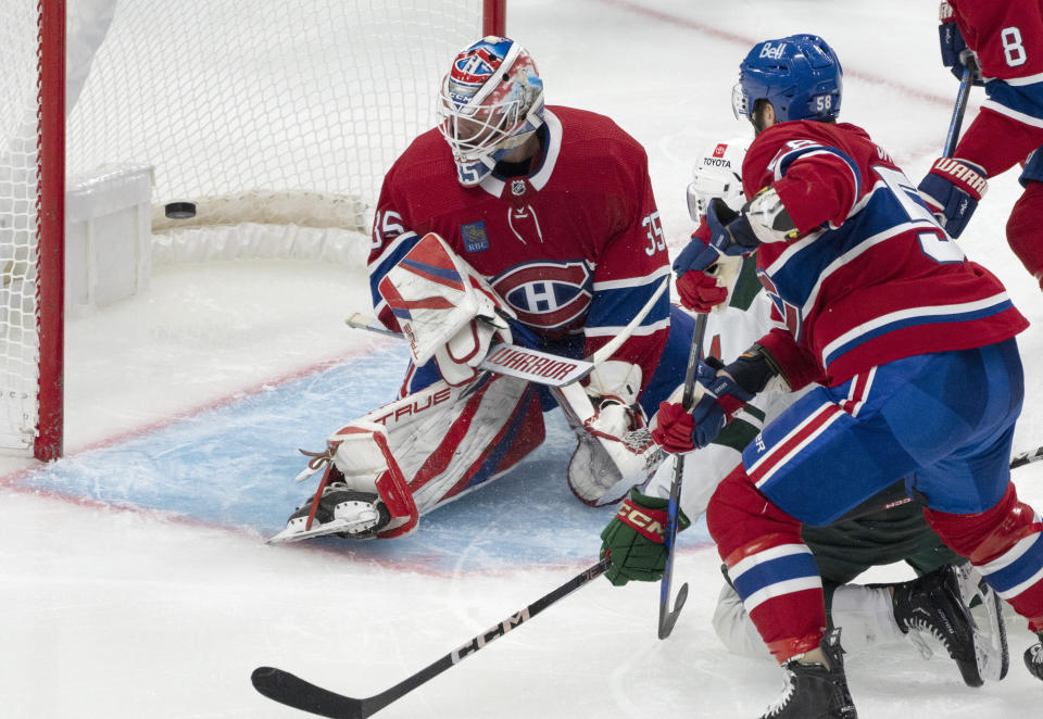 Minnesota Wild's Joel Eriksson Ek (14) scores on Montreal Canadiens goaltender Sam Montembeault (35) as David Savard (58) tries to defend during the second period of an NHL hockey game, Tuesday, Oct. 17, 2023 in Montreal. (Christinne Muschi/The Canadian Press via AP)
