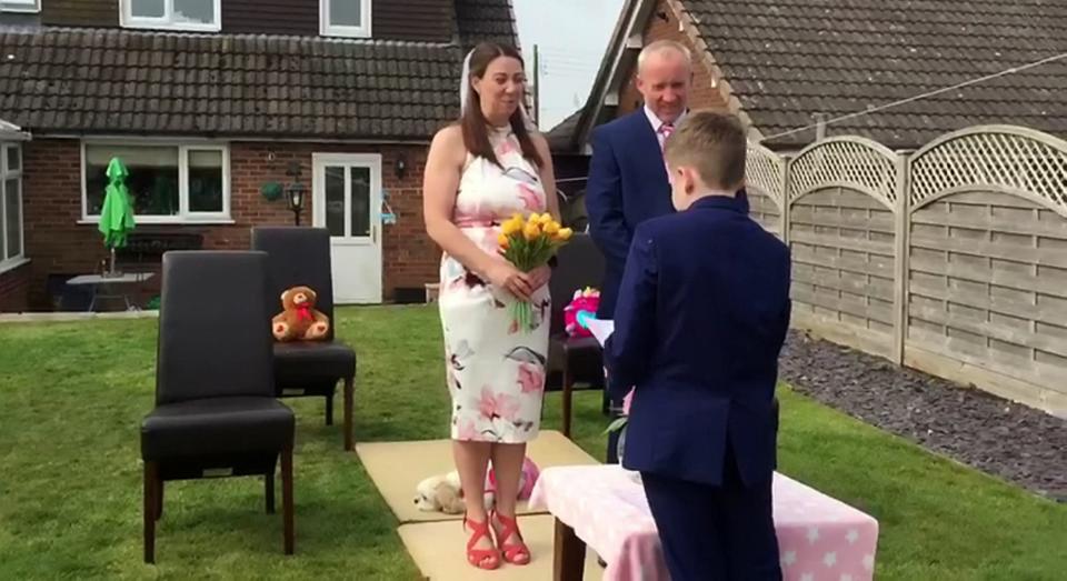 A couple who were forced to cancel their wedding have tied the knot in a surprise garden ceremony thrown by their kids (SWNS)