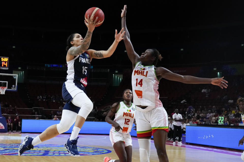 France's Gabby Williams lays up for a shot at goal as Mali's Sika Kone, right, attempts to block during their game at the women's Basketball World Cup in Sydney, Australia, Sunday, Sept. 25, 2022. (AP Photo/Mark Baker)