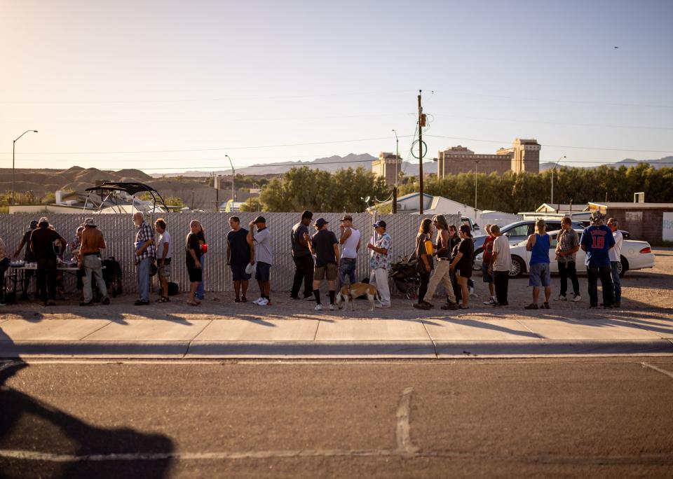 People, many of whom are currently experiencing homelessness, line up to receive a free meal from Norma Thornton in Bullhead City, Ariz., on Tuesday, Oct. 24, 2023. | Spenser Heaps, Deseret News