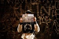 A "pichador", a graffiti artist who tags buildings and landmarks with angular, runic fonts, holds a paper with personal signatures, called "pichacao", during the "Dia do Point" (Meeting Point Day) in Sao Paulo, Brazil, April 20, 2017. REUTERS/Nacho Doce