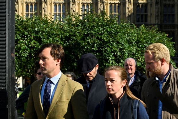 English former football player David Beckham (rear C) leaves Westminster Hall, at the Palace of Westminster, in London on <a href="https://parade.com/living/september-holidays-observances" rel="nofollow noopener" target="_blank" data-ylk="slk:September;elm:context_link;itc:0;sec:content-canvas" class="link ">September</a> 16, 2022 after paying his respects to the coffin of Queen Elizabeth II as it Lies in State. - Queen Elizabeth II will lie in state in Westminster Hall inside the Palace of Westminster, until 0530 GMT on September 19, a few hours before her funeral, with huge queues expected to file past her coffin to pay their respects. (Photo by Louisa Gouliamaki / AFP) (Photo by LOUISA GOULIAMAKI/AFP via Getty Images)<p><a href="https://www.gettyimages.com/detail/1243277814" rel="nofollow noopener" target="_blank" data-ylk="slk:LOUISA GOULIAMAKI/Getty Images;elm:context_link;itc:0;sec:content-canvas" class="link ">LOUISA GOULIAMAKI/Getty Images</a></p>