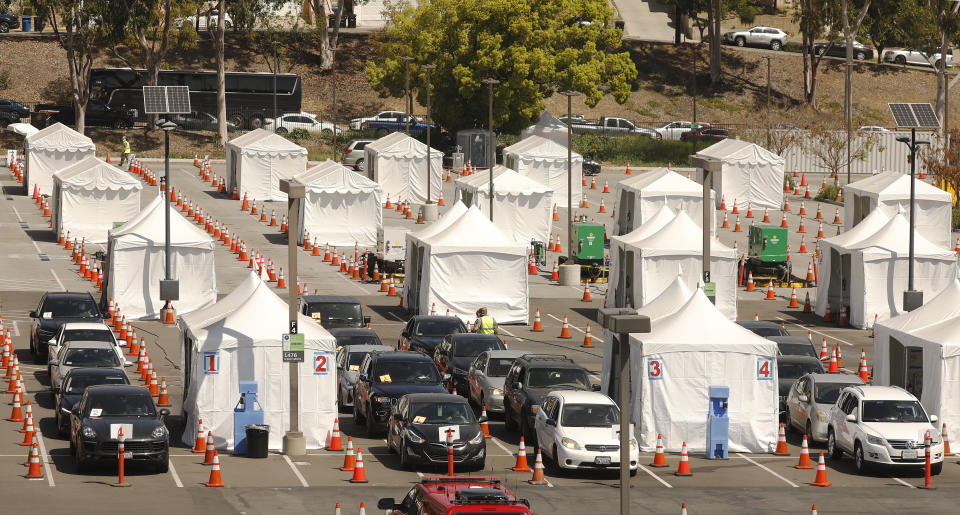 National Guard members administer the COVID-19 vaccination at a drive-thru vaccination center at California State University Los Angeles on April 8. (Photo: Al Seib/Los Angeles Times via Getty Images)