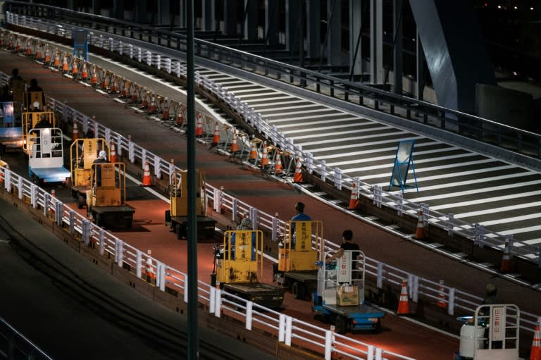 Tsukiji's workers drive their famous turret truck towards the new market's home