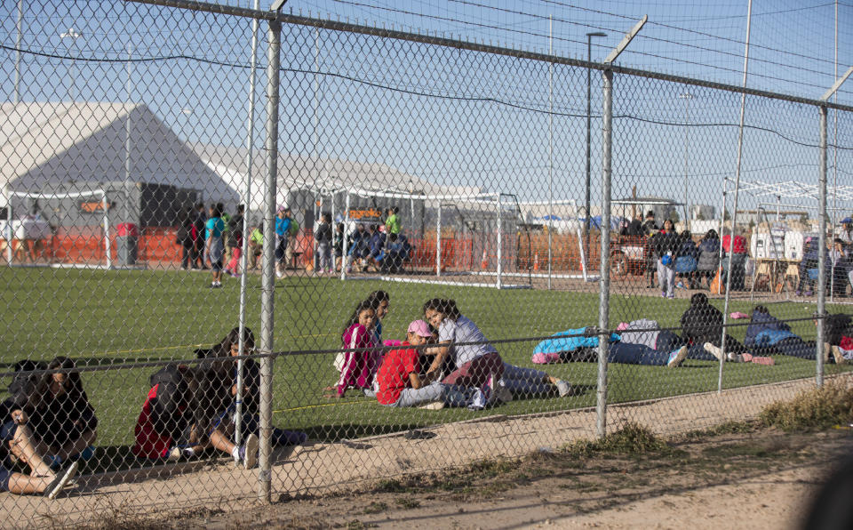 CORRECTS TO CLARIFY TEENS WERE NOT LOOKING AT PROTESTERS AS THERE WERE NOT PROTESTS THAT DAY - In this Nov. 25, 2018 photo provided by Ivan Pierre Aguirre, migrant teens held inside the Tornillo detention camp sit inside the facility in Tornillo, Texas. The Trump administration announced in June 2018 that it would open the temporary shelter for up to 360 migrant children in this isolated corner of the Texas desert. Less than six months later, the facility has expanded into a detention camp holding thousands of teenagers - and it shows every sign of becoming more permanent. (Ivan Pierre Aguirre via AP)