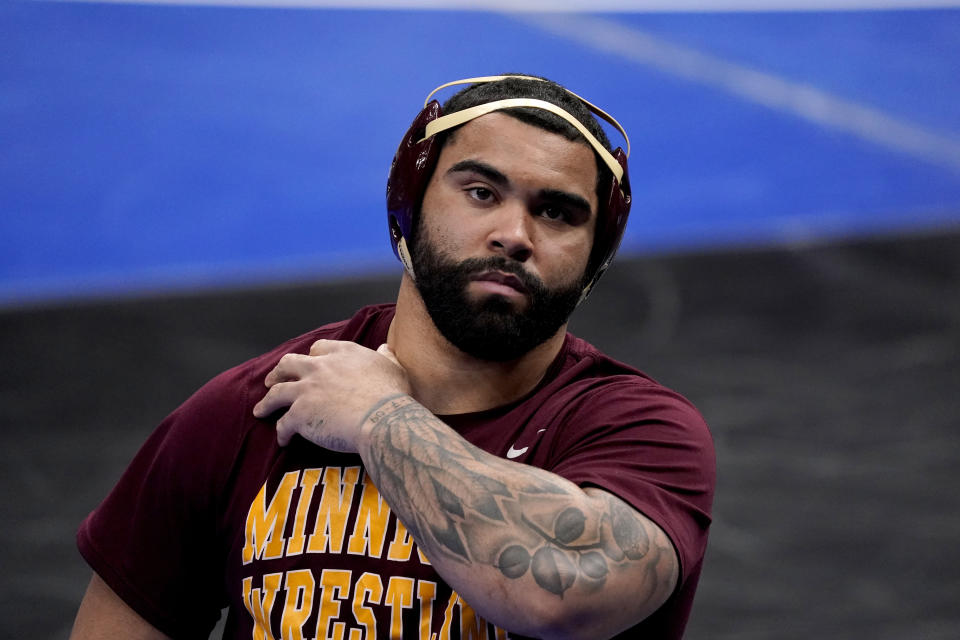 FILE - Minnesota's Gable Steveson prepares to take on Penn State's Greg Kerkvliet during their 285-pound match in the quarterfinal round of the NCAA wrestling championships in St. Louis, in this Friday, March 19, 2021, file photo. Steveson looks to become one of the youngest U.S. wrestling gold medalists ever when he competes at 125 kilograms in Tokyo. The charismatic 21-year-old hopes a successful run at the Games launches him into a WWE career like his mentor, Brock Lesnar, and an acting career like former WWE star Dwayne 'The Rock' Johnson. (AP Photo/Jeff Roberson, File)