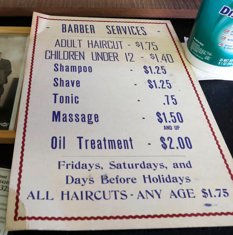 An old pricing poster at Antonie’s Barber Shop as seen, Tuesday, August 22, 2023, in Two Rivers, Wis.