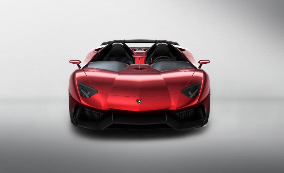 Starting with the everyday 700-hp Aventador, Lamborghini taunted the bull even further by removing the roof, adding several aerodynamic panels and generally shucking weight from a car that only had 3,472 lbs. to begin with. Even the seat fabrics have been swapped for something Lamborghini calls "Carbonskin," a fabric made from carbon fibers that's at least a decade away from being used on a teenager's hat. With no windshield, the interior has to get some form of waterproofing; the rear mirror pops up like Wall-E's head from the center of the dash. It and the roll bars behind the driver are the highest points in the car.