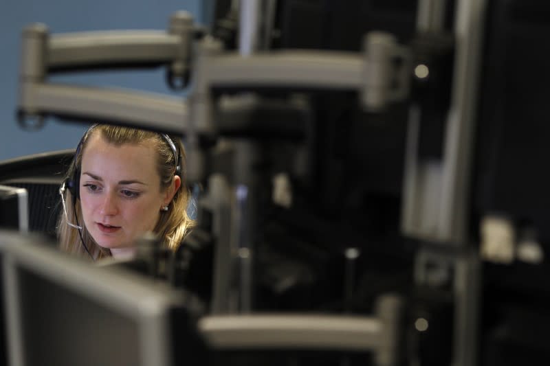 A trader monitors her screen on a trading floor in London January 22, 2010. REUTERS/Stefan Wermuth/Files