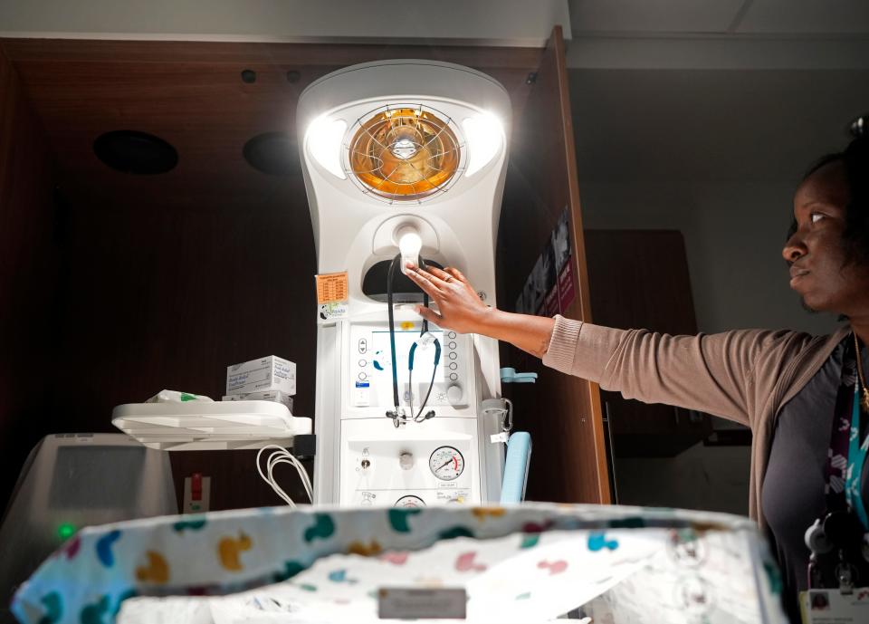 Jatu Boikai, a Mount Carmel Grove City nurse manager, turns on a baby warmer in a labor and delivery room. Boikai has hired 25 Black employees since she started at the Grove City hospital in 2020.