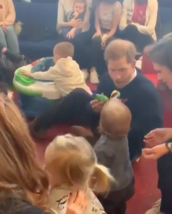 Harry got down on the carpet to play with some junior fans. Photo: Instagram/sussexroyal.