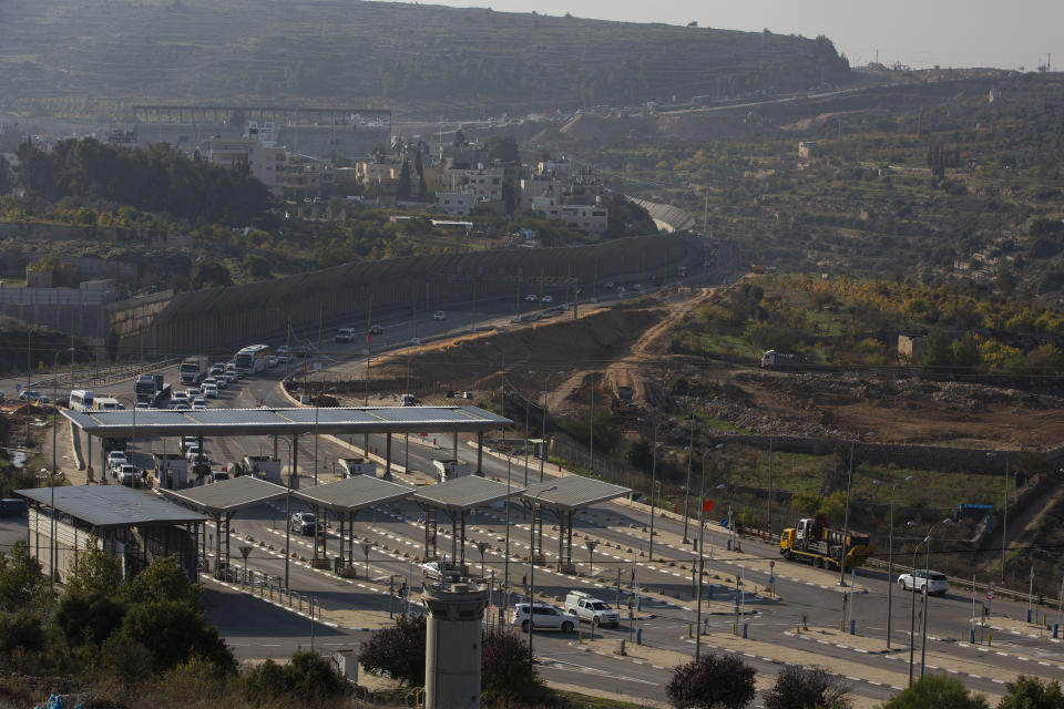 FILE - In this Sunday, Nov. 29, 2020. file photo, roadworks expand a road to Israeli settlements inside the West Bank, near the city of Bethlehem. Israel's premier human rights group has begun describing both Israel and its control of the Palestinian territories as a single "apartheid" regime, using an explosive term that the Israeli government and its supporters vehemently reject. (AP Photo/Majdi Mohammed, File)