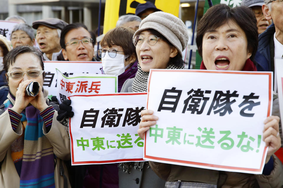 Protesters hold placards reading "Do not send Japan's Self-Defense Forces to Middle East" outside the prime minister's official residence in Tokyo Friday, Dec. 27, 2019. Japan on Friday approved a contentious plan to send its naval troops to the Middle East to contribute to the peace and stability in the area and ensure the safety of Japanese ships transporting oil, a mission crucial to an energy-poor country that heavily depends on oil imports from the region. (Hiroki Yamauchi/Kyodo News via AP)