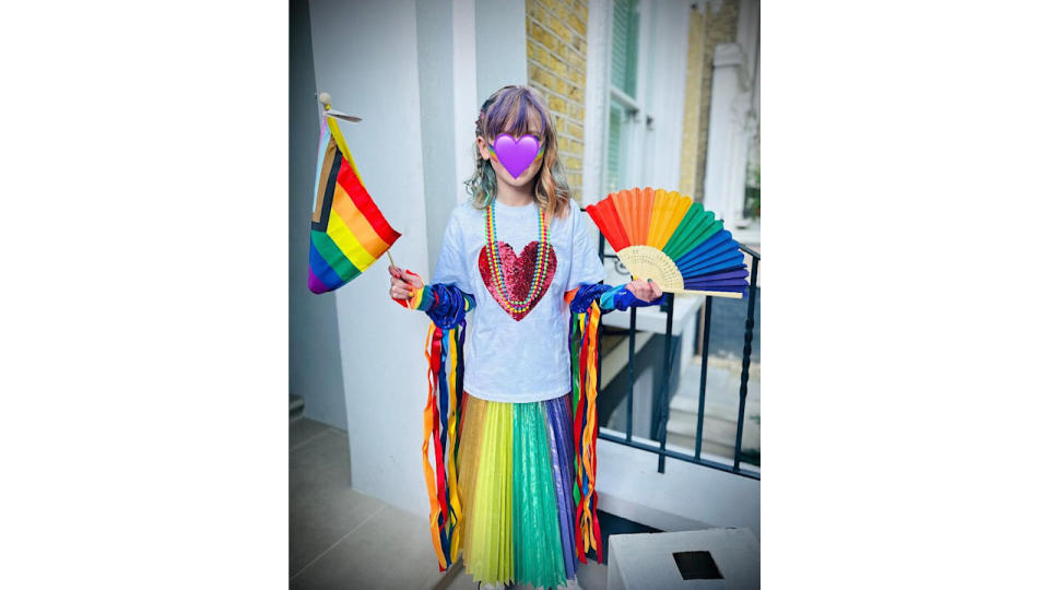 David and Georgia Tennant's daughter Doris holding Pride paraphenalia 