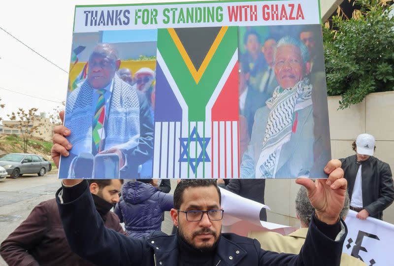 Demonstrators protest as judges at the ICJ in the Hague hear a request for emergency measures to order Israel to stop its military actions in Gaza, in Amman