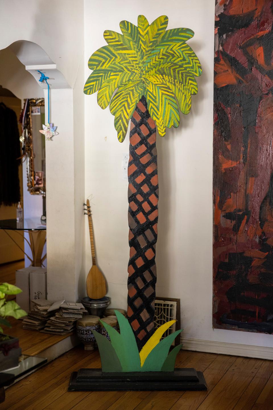 A sculture of a pine tree is seen in a home.