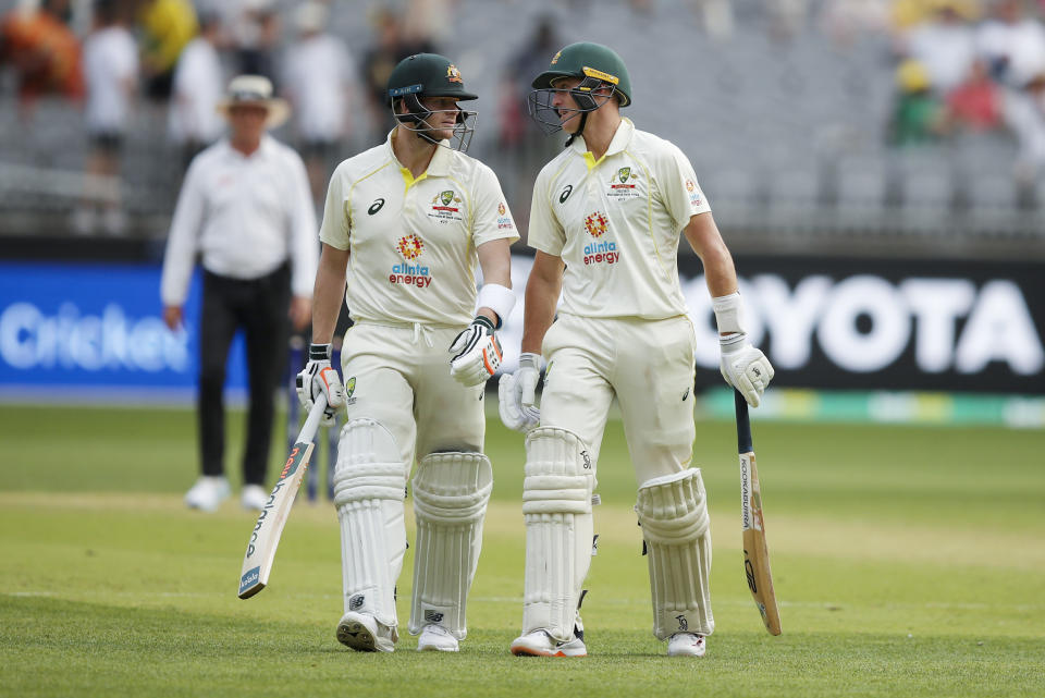 Australia's Steve Smith talks to teammate Marnus Labuschagne, right, as they leave the field at the close of play on the first day of the first cricket test between Australia and the West Indies in Perth, Australia, Wednesday, Nov. 30, 2022. (AP Photo/Gary Day)