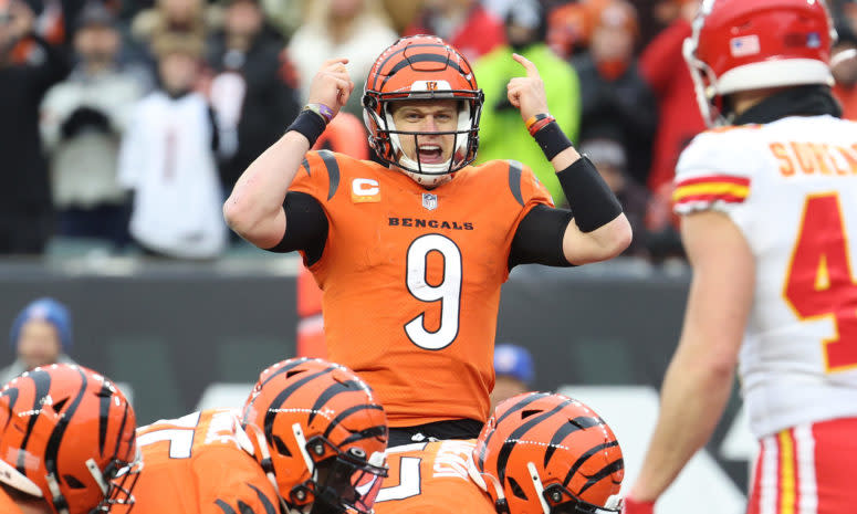 Cincinnati Bengals quarterback Joe Burrow points at his helmet with both hands before snapping the ball.