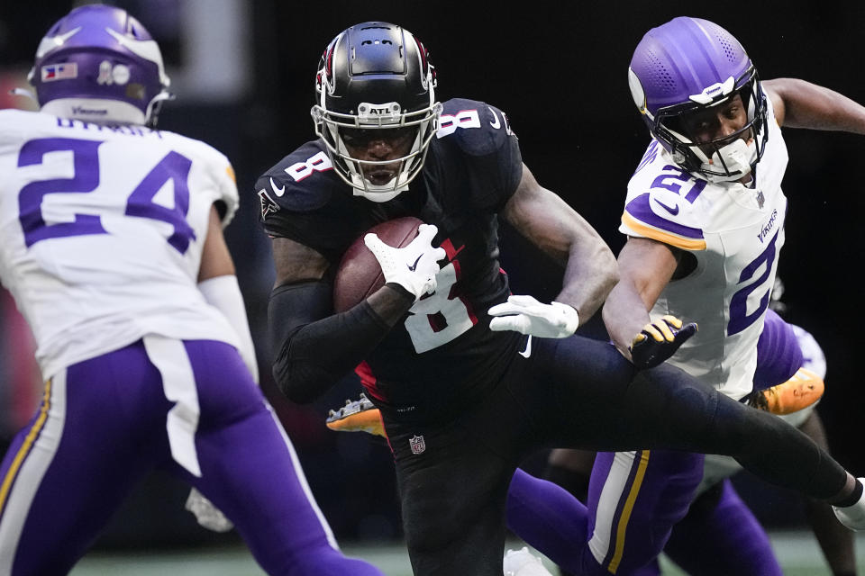 Atlanta Falcons tight end Kyle Pitts (8) runs the ball past Minnesota Vikings safety Camryn Bynum (24) and cornerback Akayleb Evans (21) during the second half of an NFL football game, Sunday, Nov. 5, 2023, in Atlanta. (AP Photo/John Bazemore)