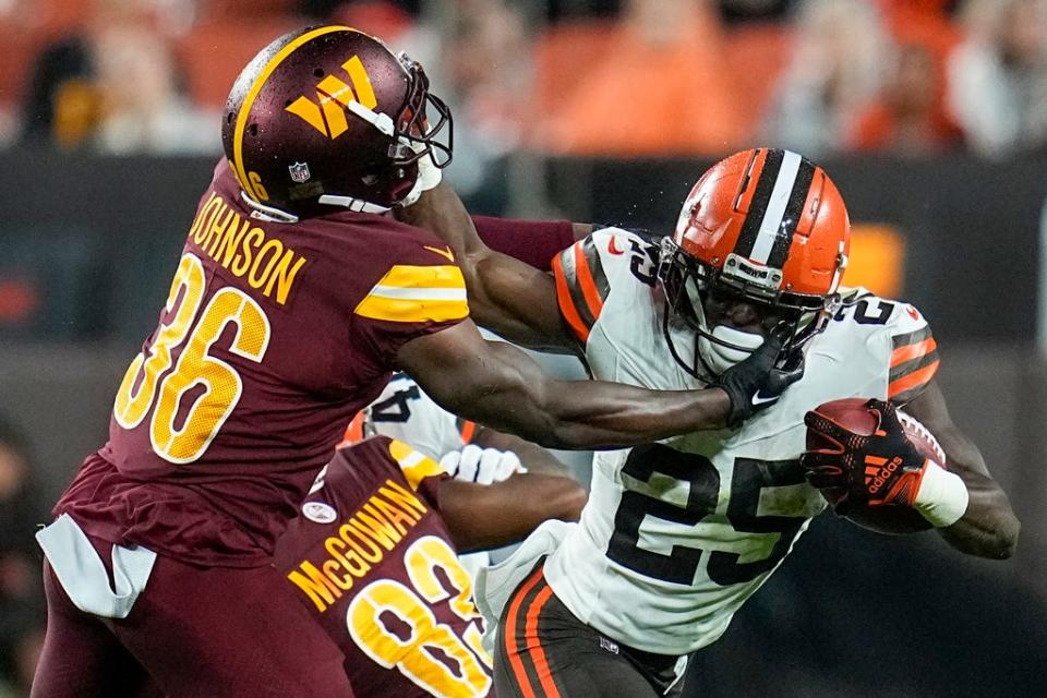 Cleveland Browns running back Demetric Felton Jr. is tackled by Washington Commanders cornerback Danny Johnson during the first half on Aug. 11 in Cleveland.