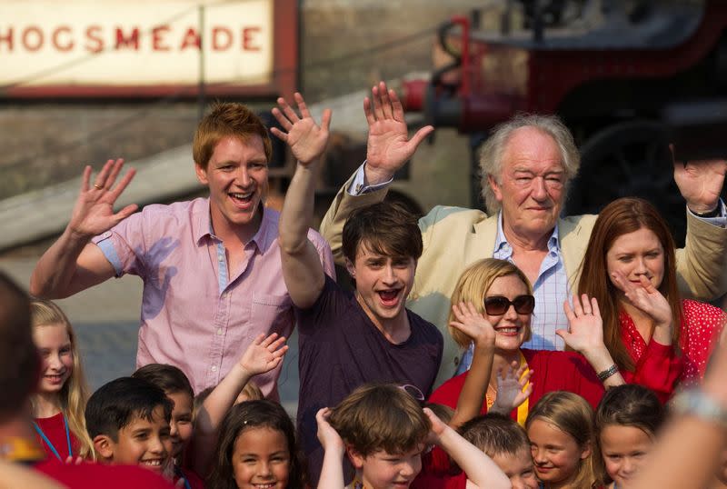 FILE PHOTO: Phelps, Radcliffe, Gambon and Wright from the "Harry Potter" movies wave during the grand opening of The Wizarding World of Harry Potter theme park in Orlando