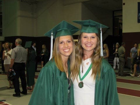 Mallory Gritsch, left, and Bri Buzick at their high school graduation in Pella.