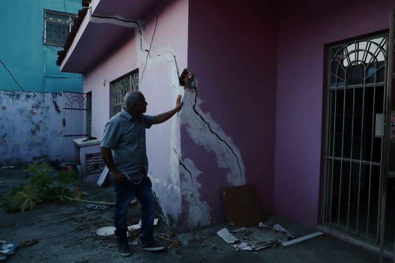 Jose Rinaldo Januario is pictured outside his house next to cracks linked to rock salt mining by the petrochemical company Braskem in Maceio