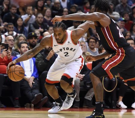 Nov 25, 2018; Toronto, Ontario, CAN; Toronto Raptors forward Kawhi Leonard (2) dribbles the ball past Miami Heat forward Justise Winslow (20) in the second half at Scotiabank Arena. Mandatory Credit: Dan Hamilton-USA TODAY Sports